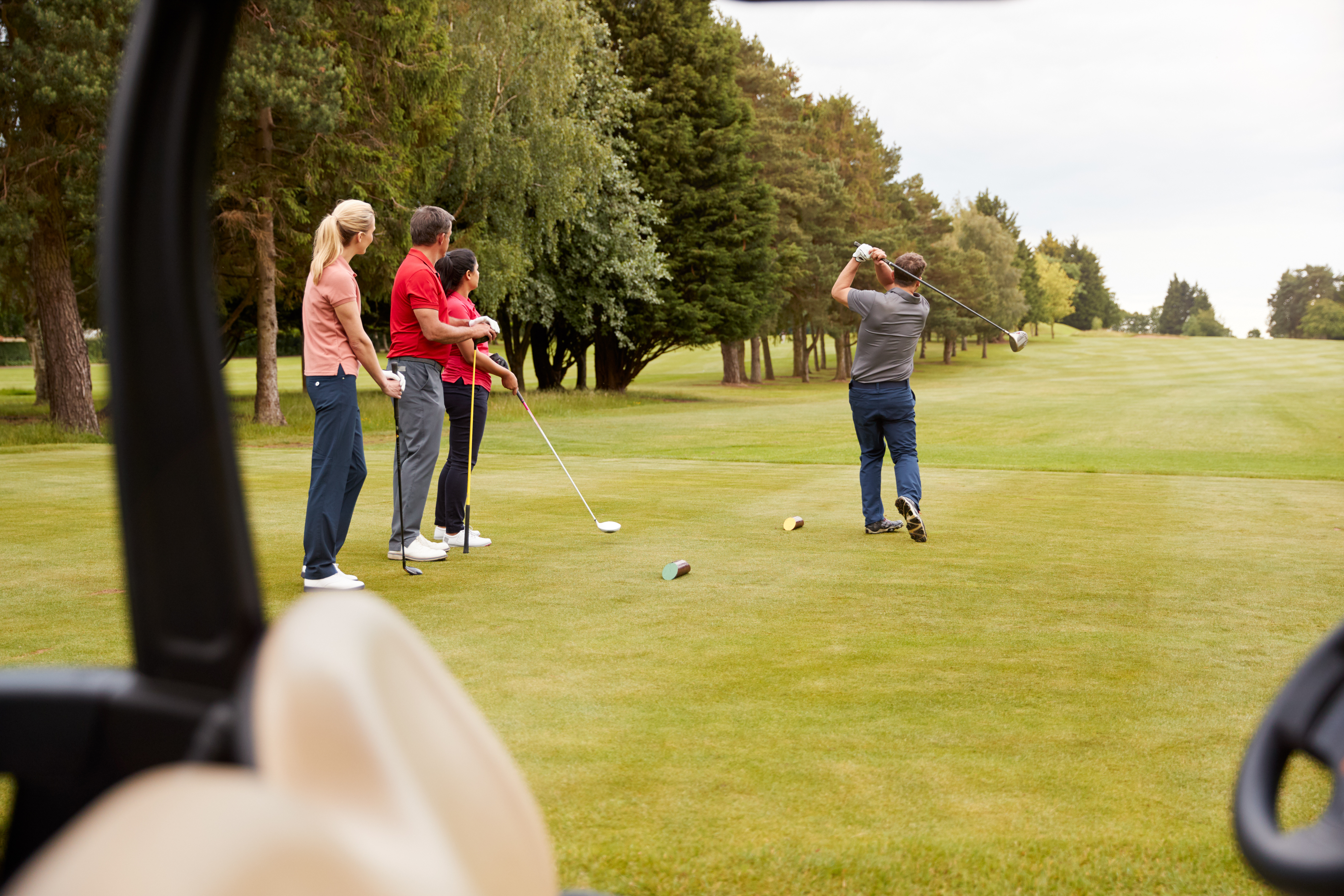 Golfers teeing off forward